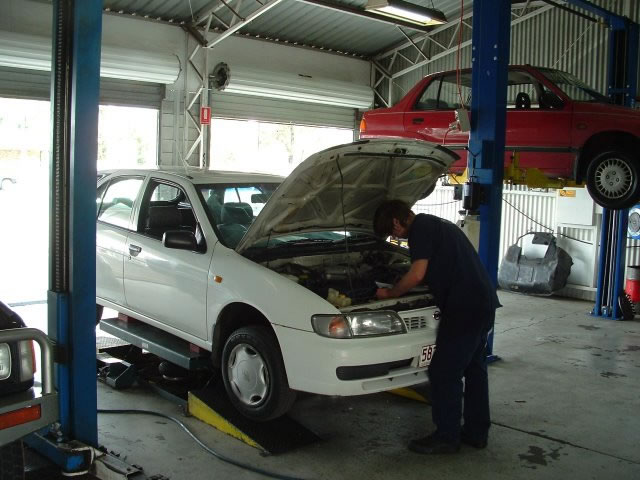 Professional mechanic working on vehicle